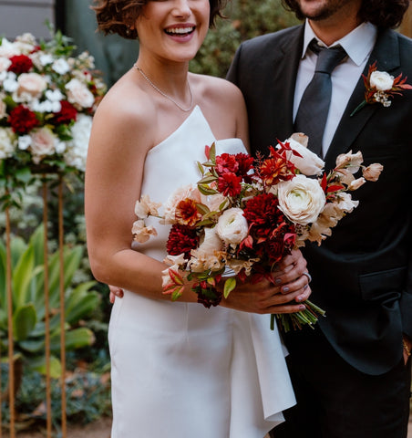 Primary of the Sunset bridal bouquet and flower cloud altar arrangement with bride and groom smiling
